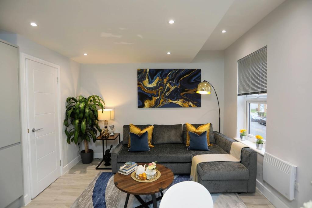 a living room with a couch and a table at Aisiki Apartments at Stanhope Road, North Finchley, a 3 Bedroom and 2 Bathroom Pet Friendly Duplex Flat, King or Twin beds with FREE WIFI in Finchley