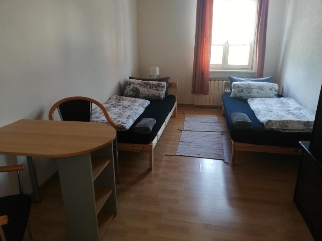 a living room with two beds and a table at Apartment White, Wohnung in Altenstadt