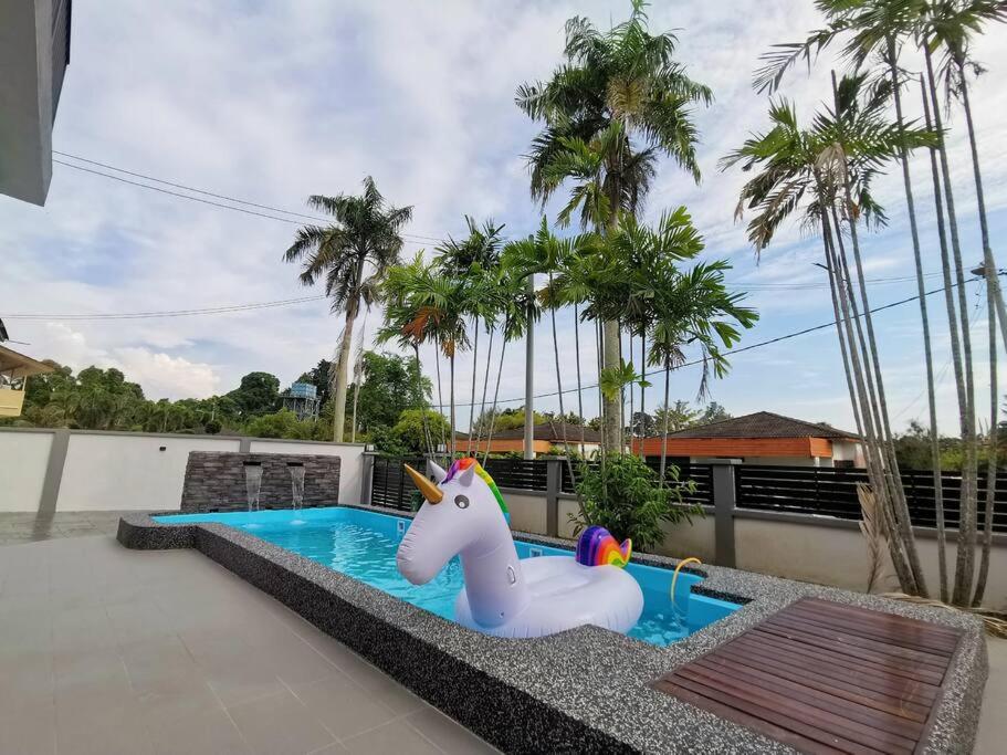 a pool with a toy unicorn in a swimming pool at Port Dickson Pool Villa - Ruma66 (Up to 22 Pax) in Port Dickson
