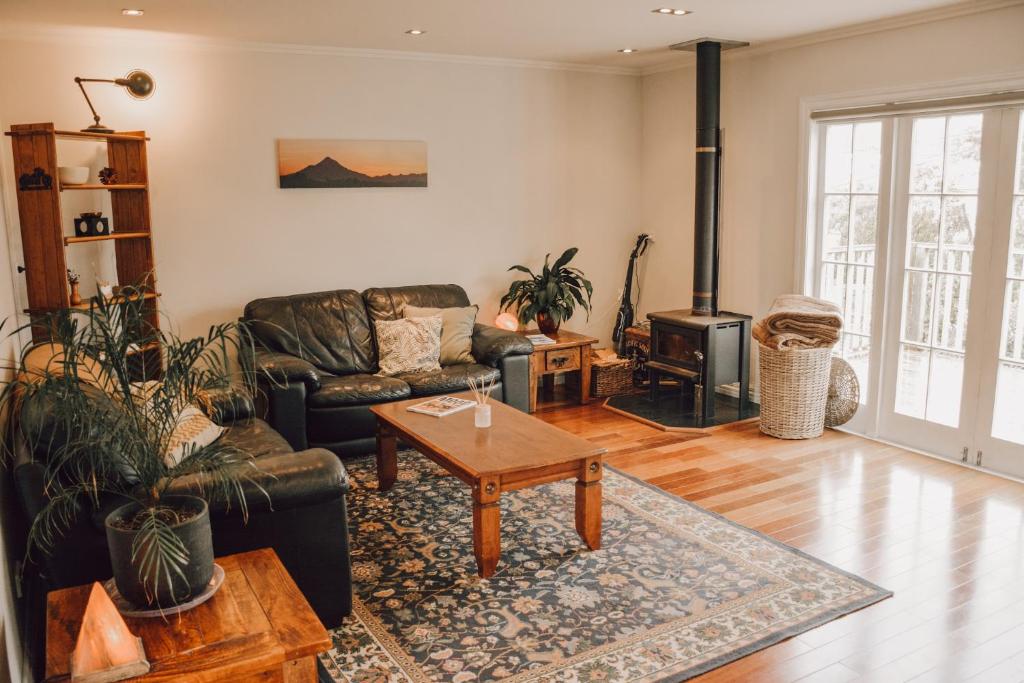 a living room with a couch and a coffee table at Little Beauty on Belt in New Plymouth