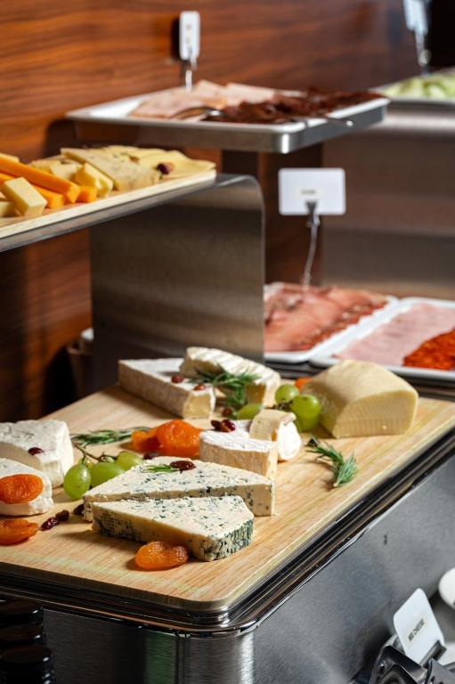 a display of cheese and other foods on a table at Hotel California by Aycon in Sveti Stefan