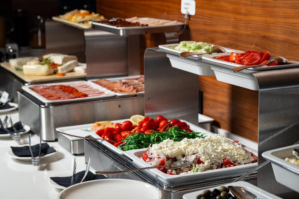 a buffet line with many different types of food at Hotel California by Aycon in Sveti Stefan