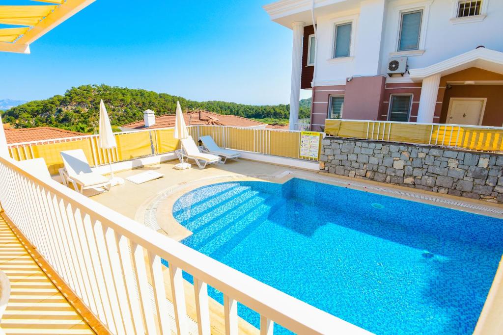 a swimming pool on the balcony of a house at Villa Rana The Royal Links Sarigerme in Ortaca