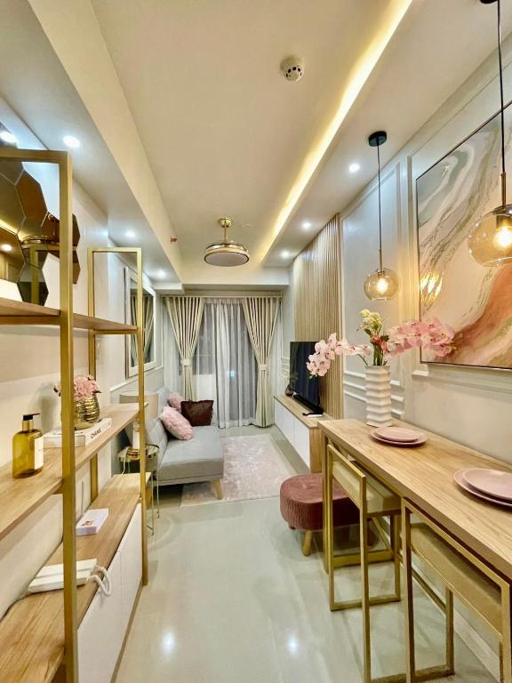 a living room with a table and a couch at LuxeRN Suite at S Residences in Manila