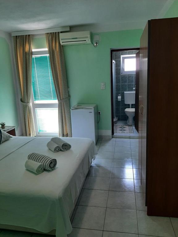 Postel nebo postele na pokoji v ubytování Guest House Aldin