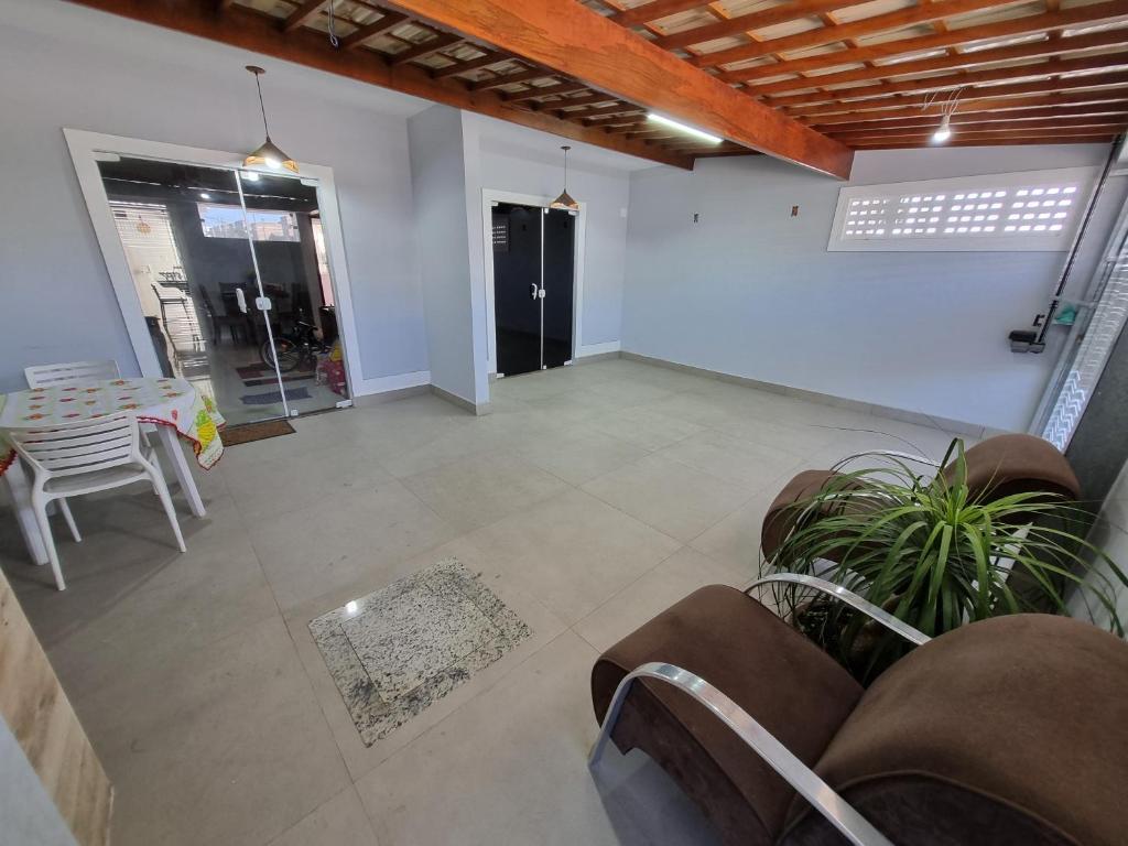 an empty living room with a table and chairs at Casa Nova Marilea in Rio das Ostras