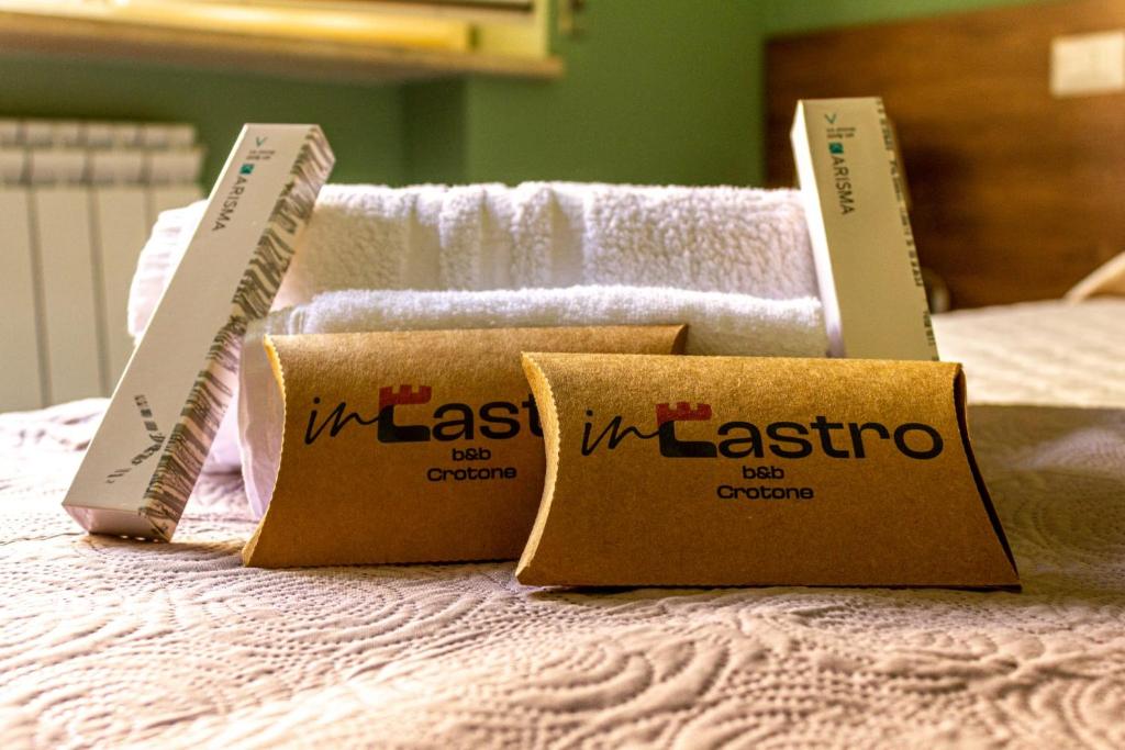 two boxes on top of a bed with towels at INCASTRO B&B IN CROTONE in Crotone