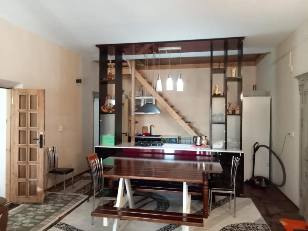 a kitchen with a wooden table and a refrigerator at Top in Türkistan