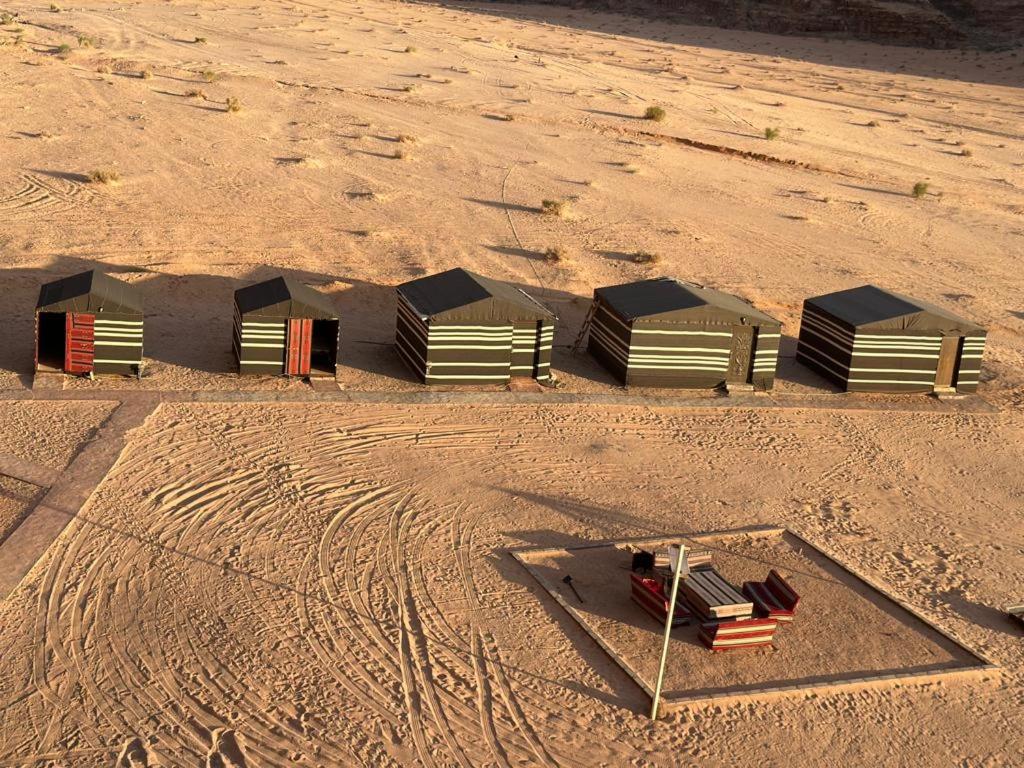 a group of structures sitting in the sand at Serenity Camp in Wadi Rum