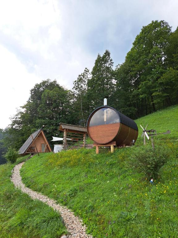 a boat sitting on top of a grassy hill at PUŽMAN Farm Glamping in Radovljica