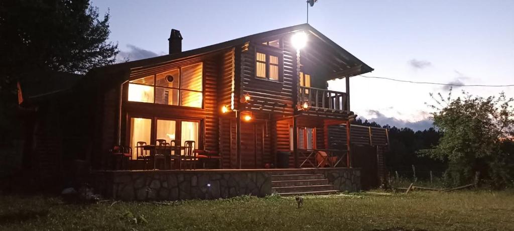 a log cabin with the sun shining on it at Chalet's lake_Bolu Abant _log house in Piroğlu