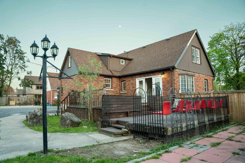 a brick house with a fence in front of it at HIDDEN GEM near the Niagara falls in Welland