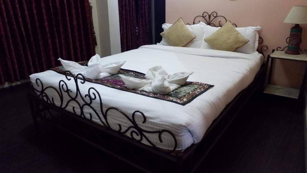 Postel nebo postele na pokoji v ubytování Cosy Hotel