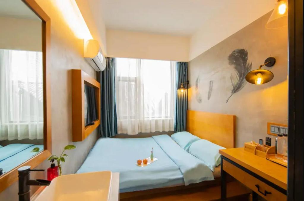 Postel nebo postele na pokoji v ubytování Gongxili - Chujian Hotel