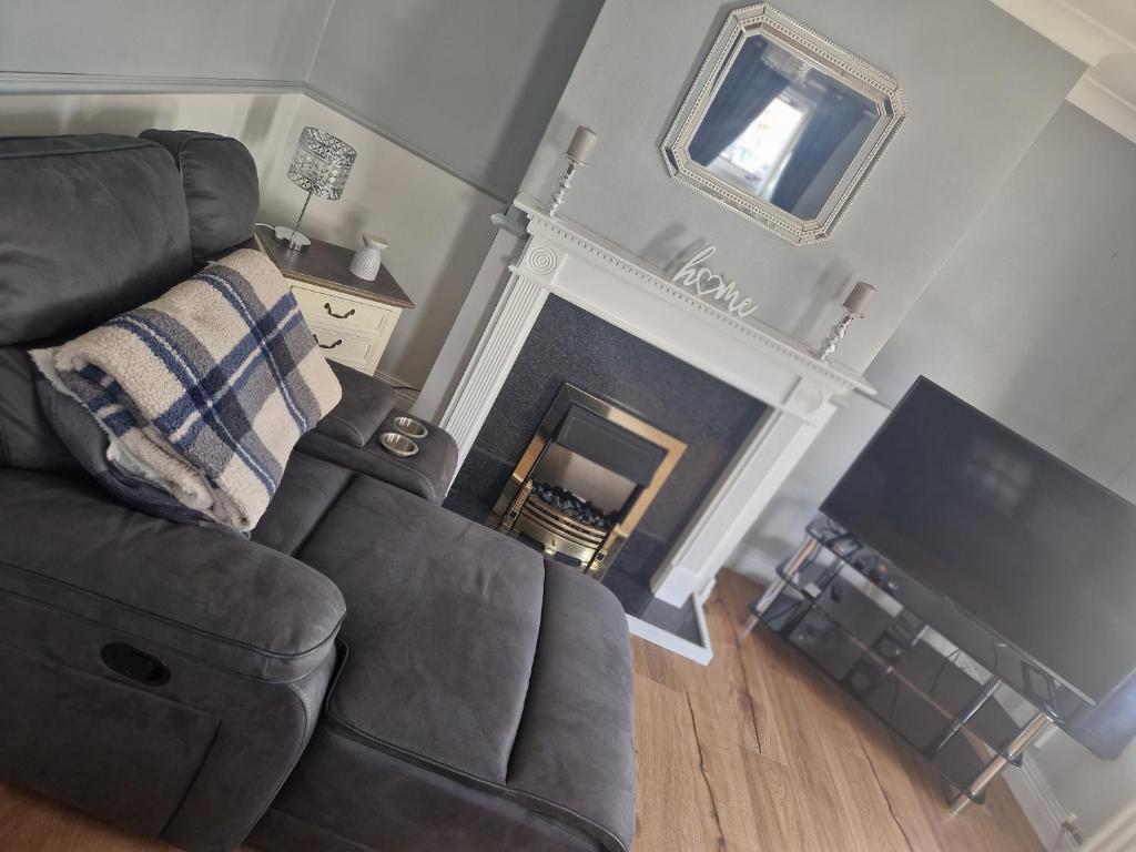 a living room with a couch and a fireplace at Cierons château in Derry Londonderry