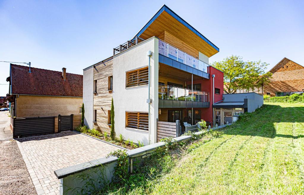 a house with a lawn in front of it at La Maison Devant La Prairie Contact O66I4O9II9 in Griesheim-près-Molsheim