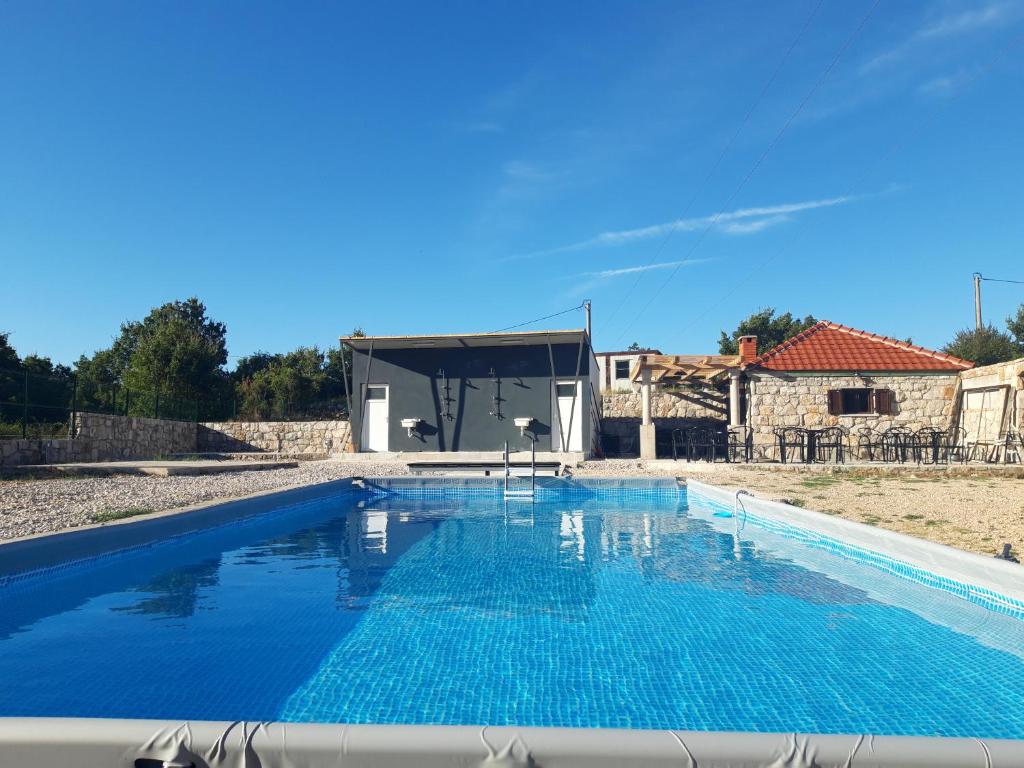 a swimming pool in a villa with a house at Kamping Luke in Trebinje
