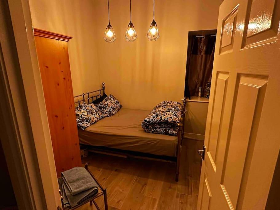 a small room with a small bed and a door at Victoria’s Dream in Aberdeen