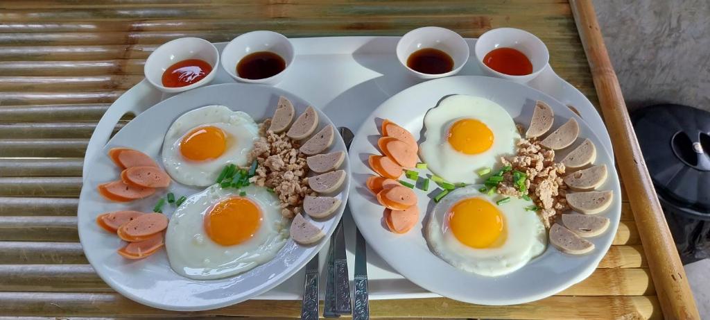 a plate of eggs and other food on a table at The Sea Campers จันทบุรี in Cham Han