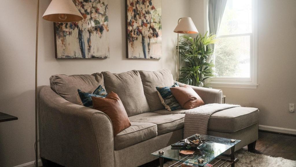 a living room with a couch and a table at King Bed~Serene Old Town Sanctuary in Alexandria