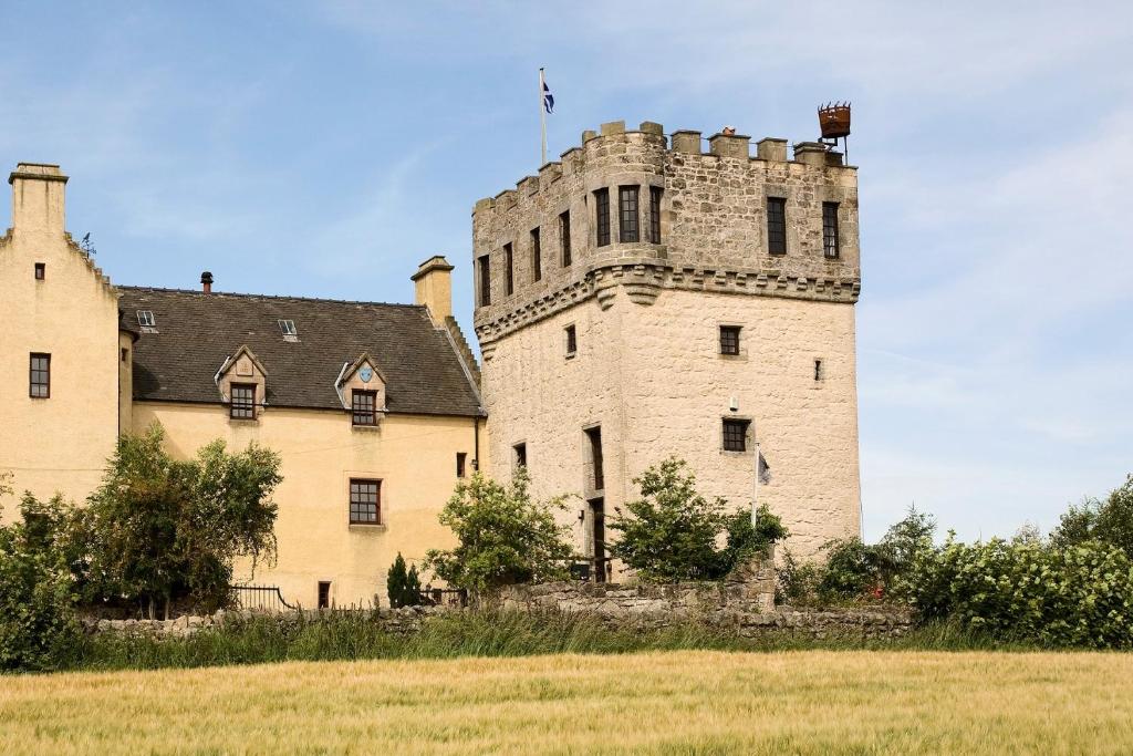an old castle with a flag on top of it at The Tower at Plane Castle in Stirling