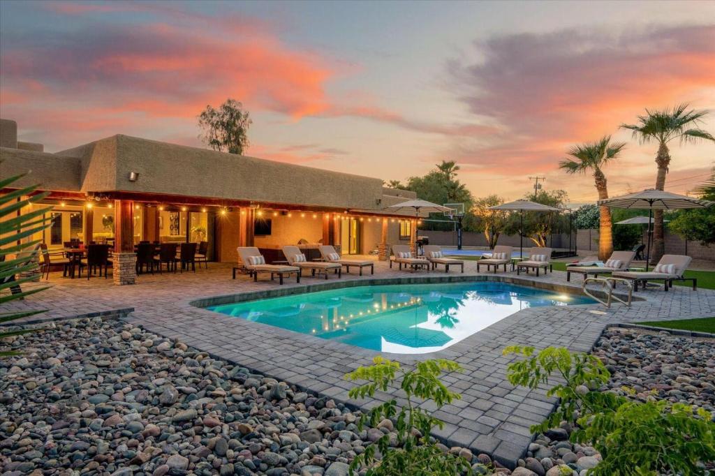 a house with a swimming pool and a patio at Escape in Elegance in Scottsdale