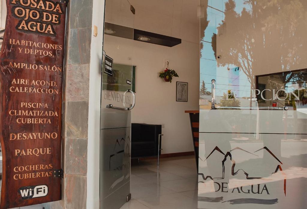 a store with a sign on the wall next to a refrigerator at Posada Ojo de Agua Villa General Belgrano in Villa General Belgrano