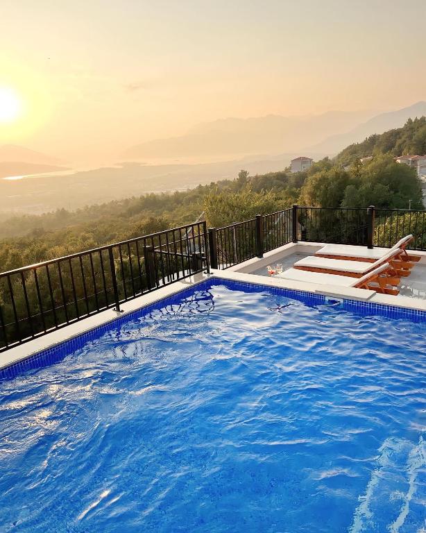 a swimming pool on a balcony with a view at Apartments HAS in Kotor