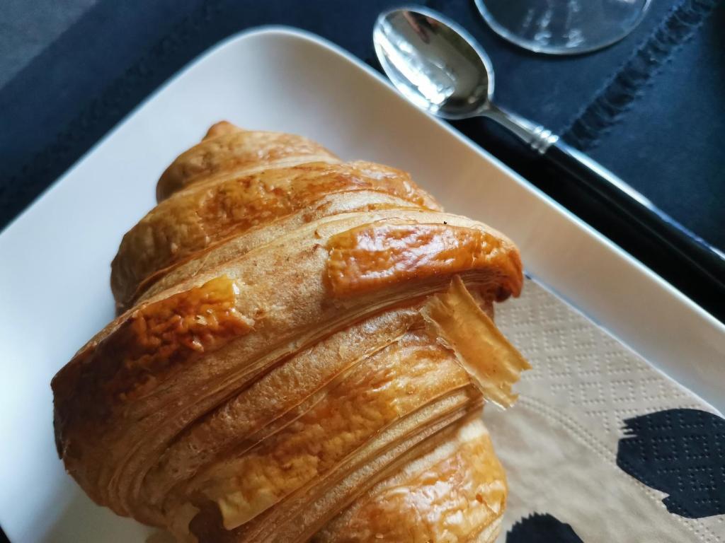 a pastry on a white plate on a table at La Maison de Ville in Compiègne