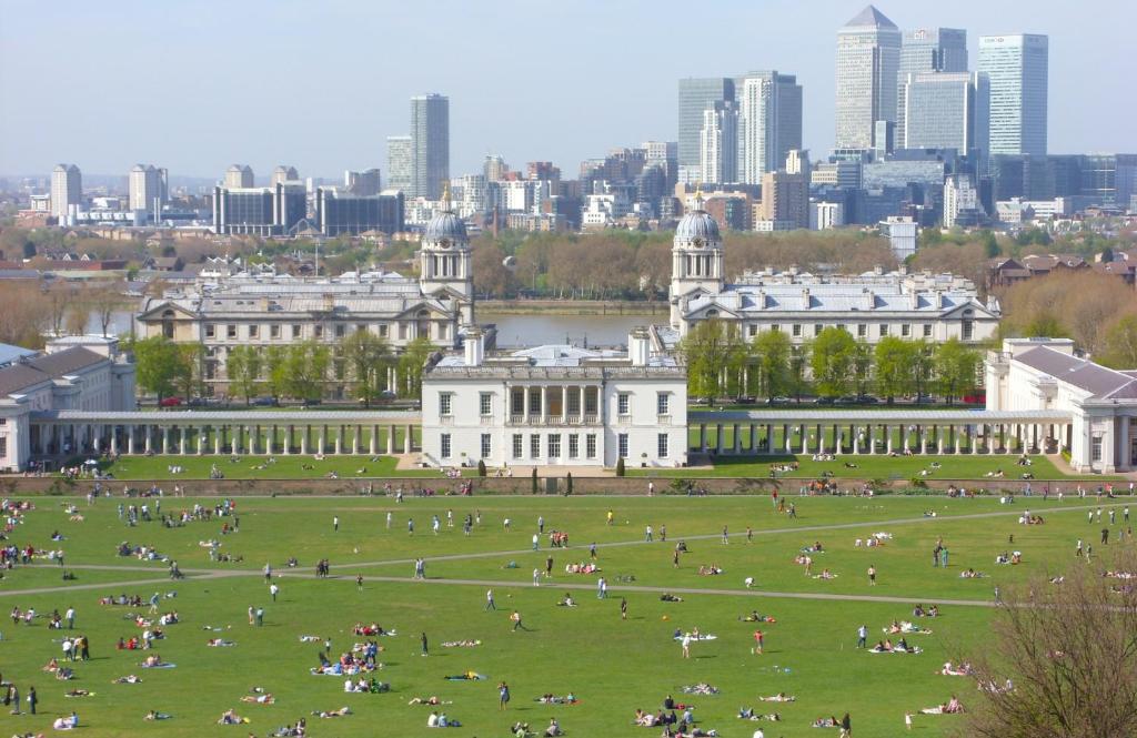 a large park in front of a building with a city at Royal Greenwich Hospitality in London