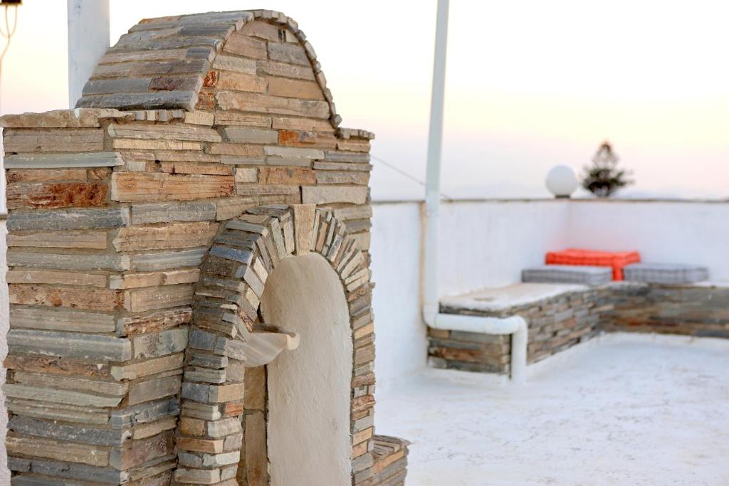 a brick oven in the middle of a room at Secret Garden Home Lagonissi Attiki in Foinikiá