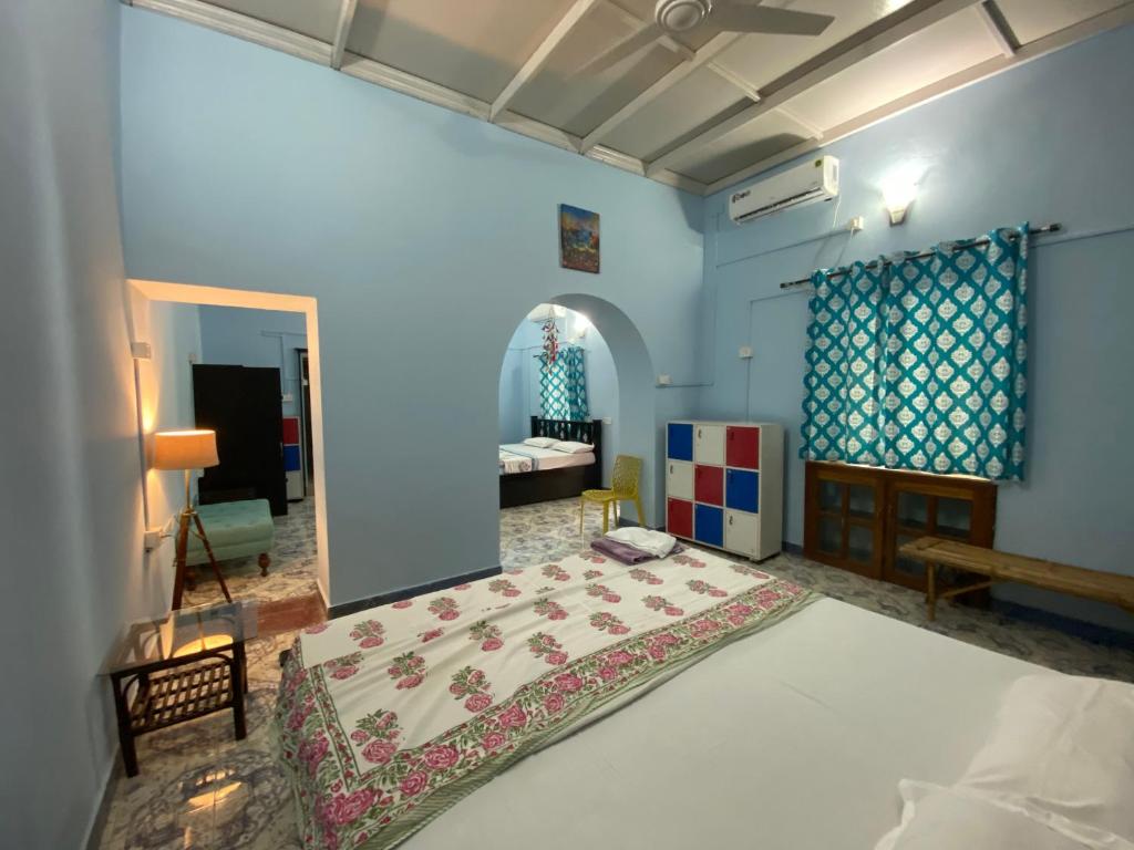 a bedroom with a large bed in a room at The Memory Lane in Siolim