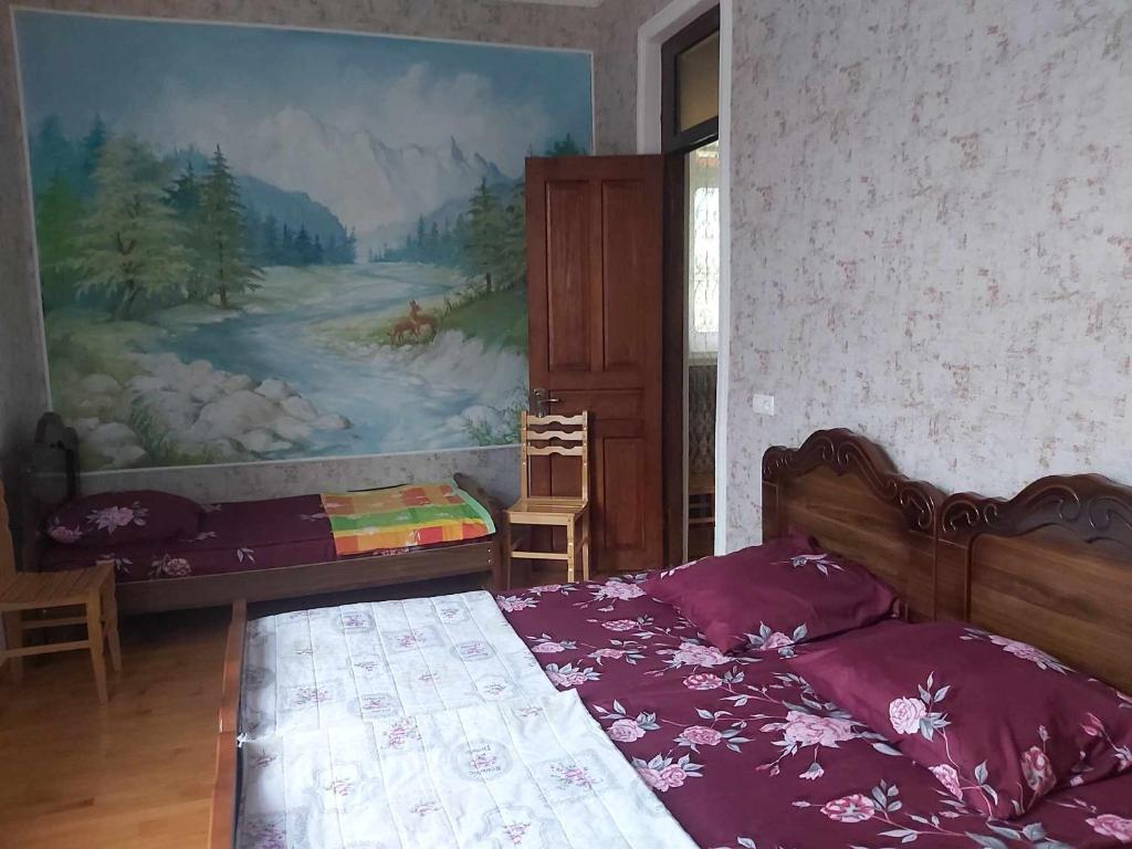 a bedroom with a bed and a painting on the wall at Martvili Canyon Room for up to 3 guests in Martvili