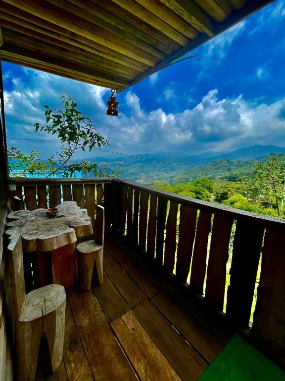 a balcony with a table and chairs and a view at Parque ecoturistico in Cali
