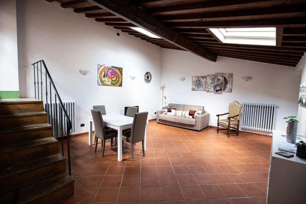 a living room with a table and chairs and a couch at YOUR APARTMENT IN FLORENCE in Florence