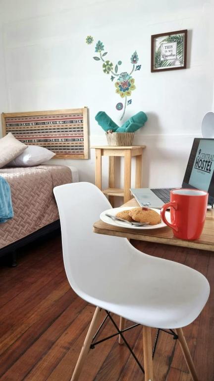 a room with a table with a plate of food at Central Hostel Reforma in Guatemala