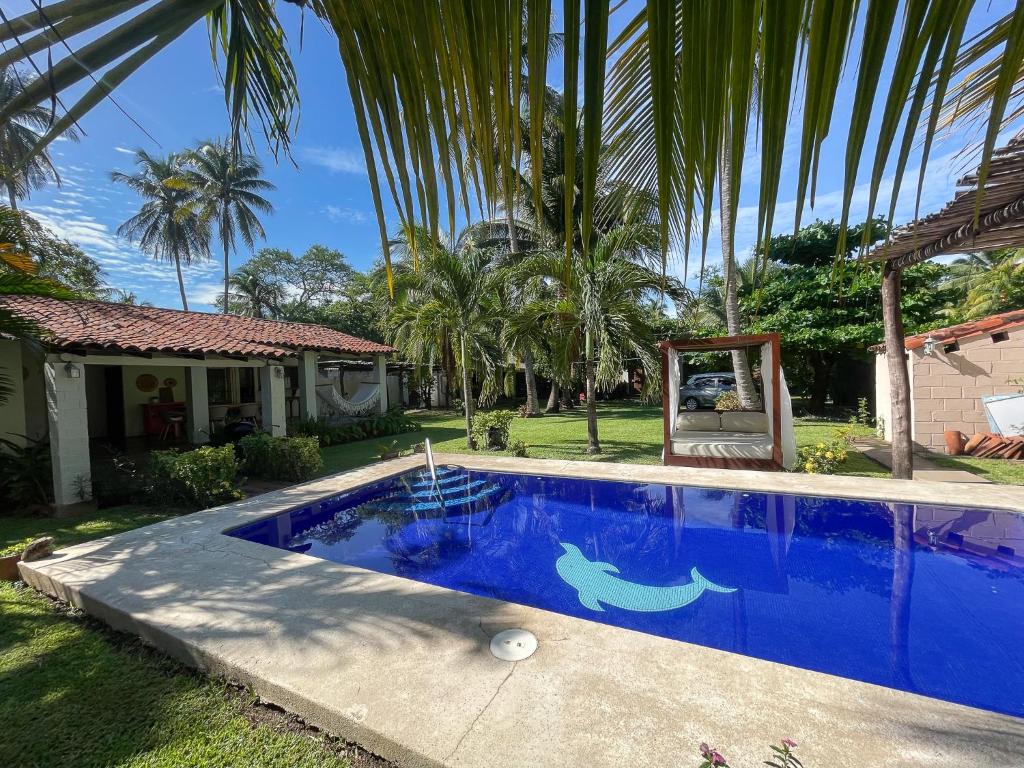 una gran piscina azul frente a una casa en Casa De Playa El Encanto, en El Porvenir