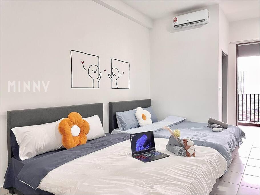a bedroom with two beds with stuffed animals on them at Netizen walk to MRT 4-5pax in Cheras
