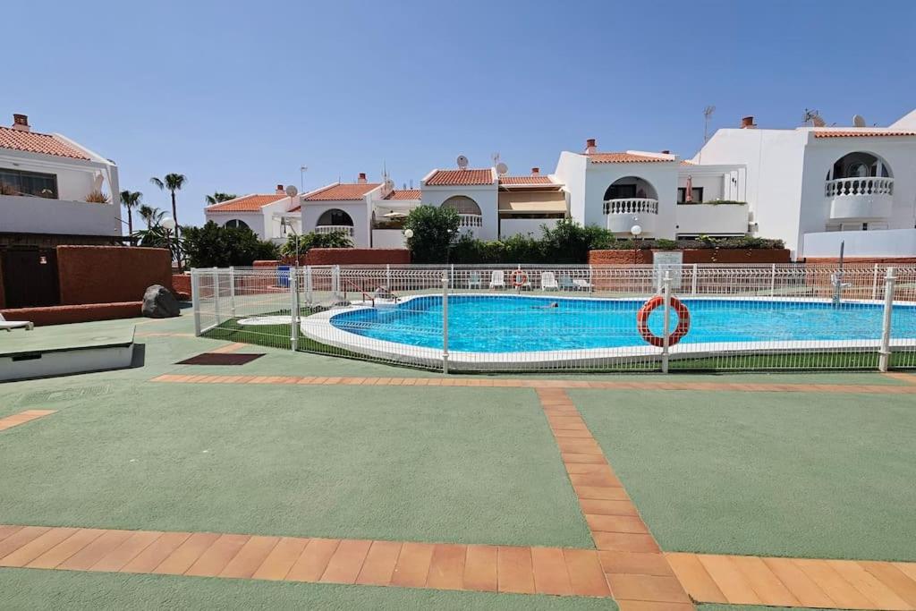 a swimming pool in front of some houses at Callao Sun & Pool in Callao Salvaje