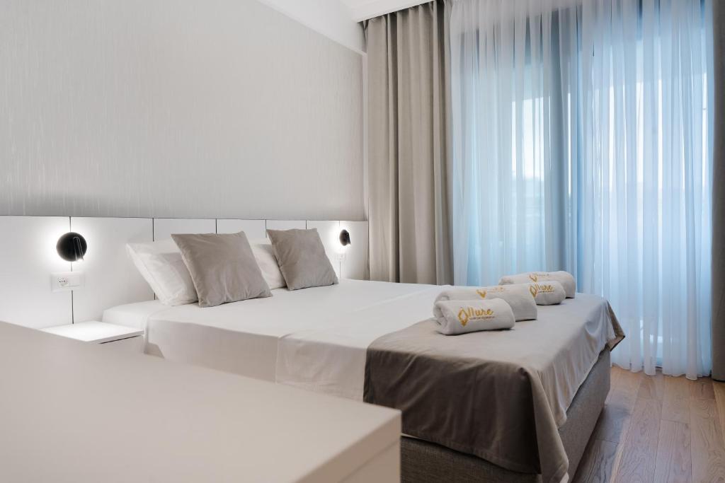 Postel nebo postele na pokoji v ubytování Kondo Hotel Allure