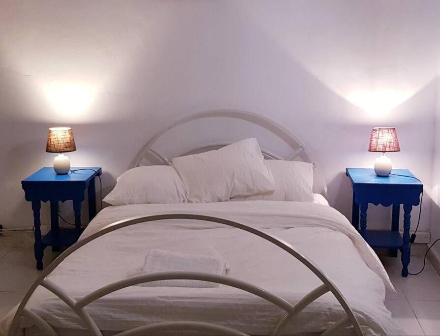 a bed with two blue nightstands next to at Níjar has been described as one of the most picturesque towns in the whole of Spain. A visit to Níjar guarantees the traveller a flavour of the ‘real’ Andalusia without the need to overspend on the trip. in Níjar