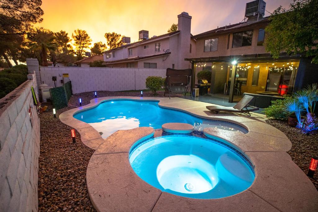 a swimming pool in the backyard of a house at 1800 SqFt House W/Heated Pool Spa 13Min From Strip in Las Vegas