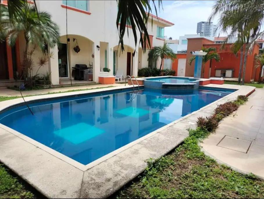 a swimming pool in front of a house at Casa /alberca, chapoteadero, mirador, wifi in Veracruz