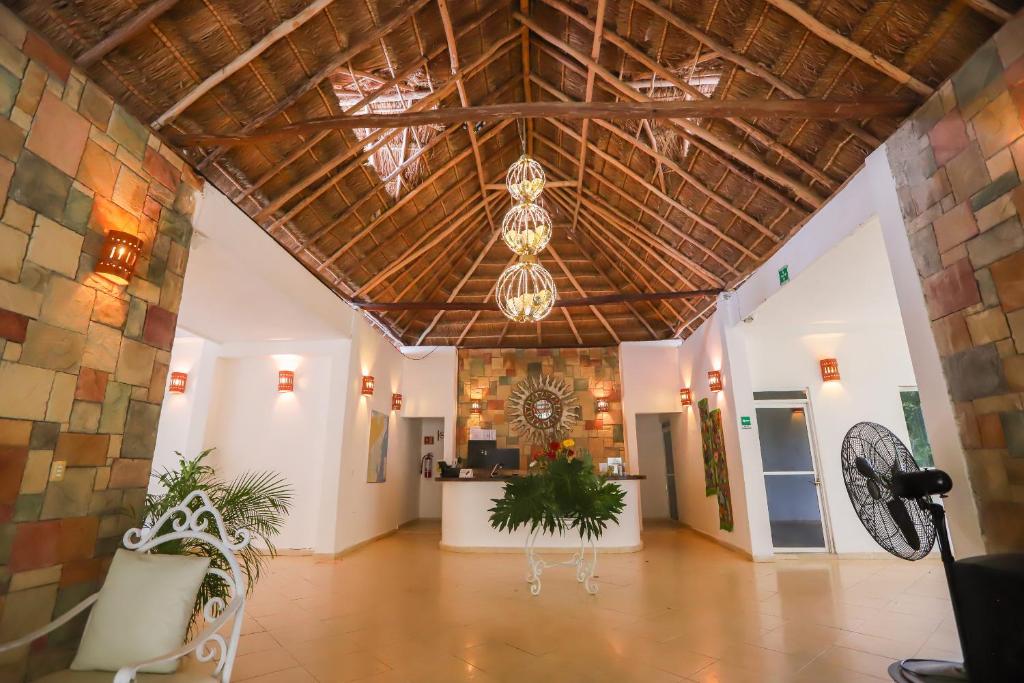 a large room with a ceiling with a chandelier at Mayan Secret Hotel Boutique in Chetumal