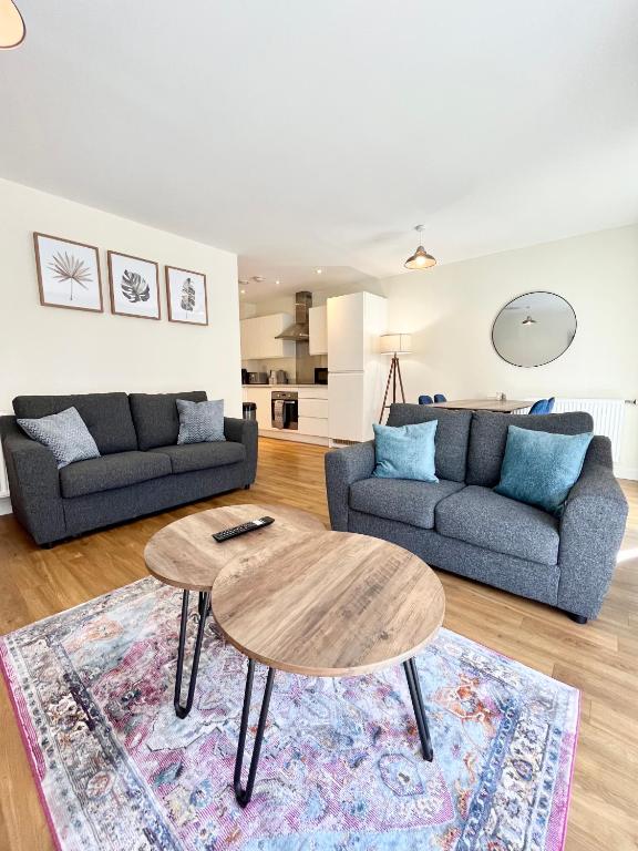 a living room with a table and a couch at Modern spacious 2 bed Apartment, close to Gunwharf Quays & Historic Dockyard - Balcony, Smart Tv, Free Parking, WiFi, Double or single beds in Portsmouth