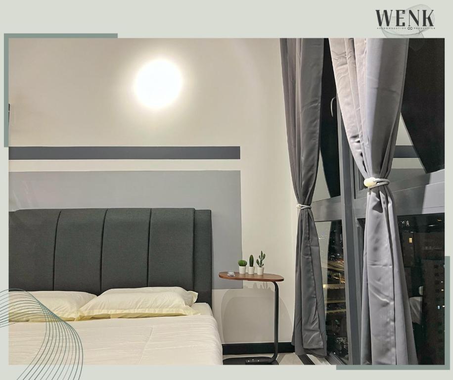 a bedroom with a bed and a window at Neu Suites @ 3RdNvenue A in Kuala Lumpur