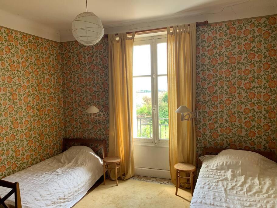 a bedroom with two beds and a window at Le Grand Libois - ancienne ferme 