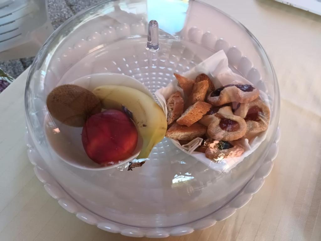 een glazen kom gevuld met voedsel op een tafel bij A Casa Nostra B&B in Cagliari