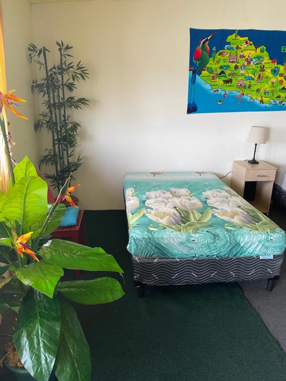 a room with a bed with a painting on the wall at Playa El Obispo E La Marea building La Libertad in La Libertad