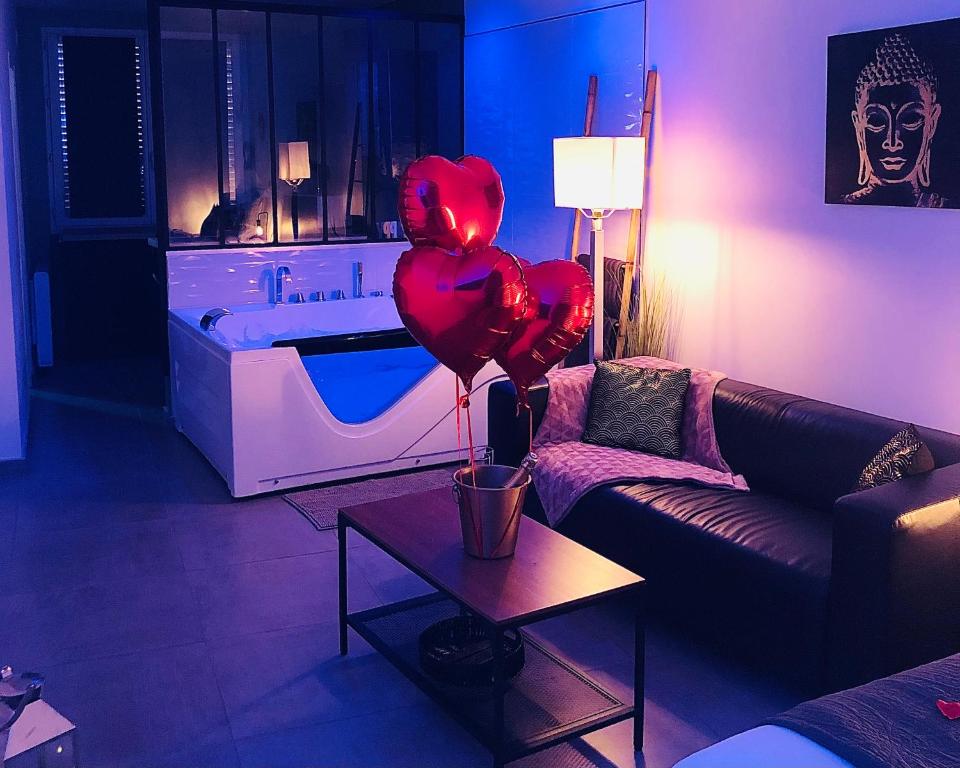 a living room with red balloons and a couch at Appart&Spa République in Dijon